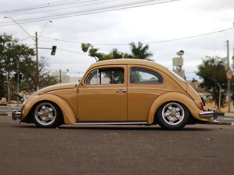 Fusca 1972 amarelo rebaixado visto de perfil lateral