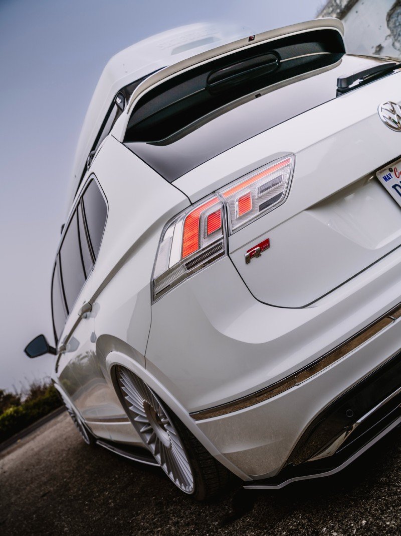 Detalhe de traseira da VW Tiguan R-Line rebaixada com lanternas acesas