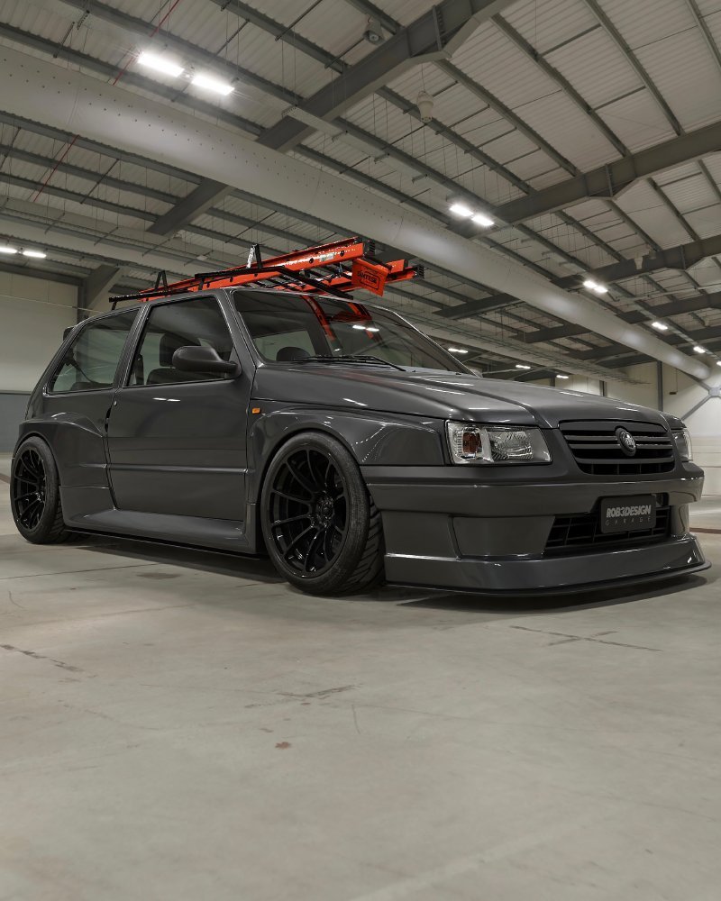 Uno Escada rebaixado em conceito 3D: Fiat Uno cinza, widebody e escada laranja no teto dentro de pavilhão