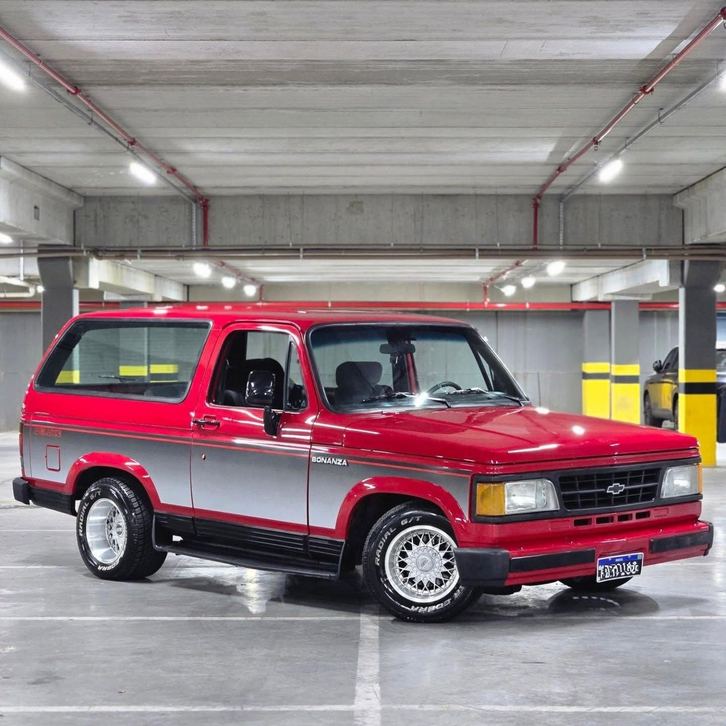 Chevrolet Bonanza rebaixada 89/90 em garagem, pintura vermelha e cinza, rodas BBS e pneus Cooper Cobra